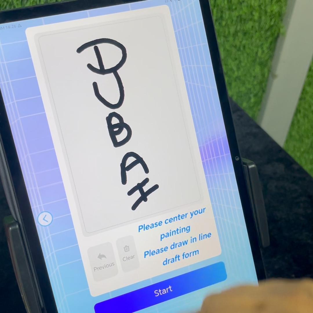 Guests using the AI Sugar Painting Robot in UAE, watching it create edible art and enjoying unique designs at events, kids activities, and parties.